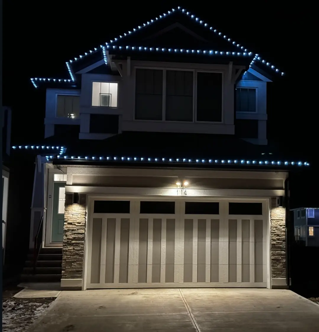 Blue roofline lights clipped in a straight line above a double garage